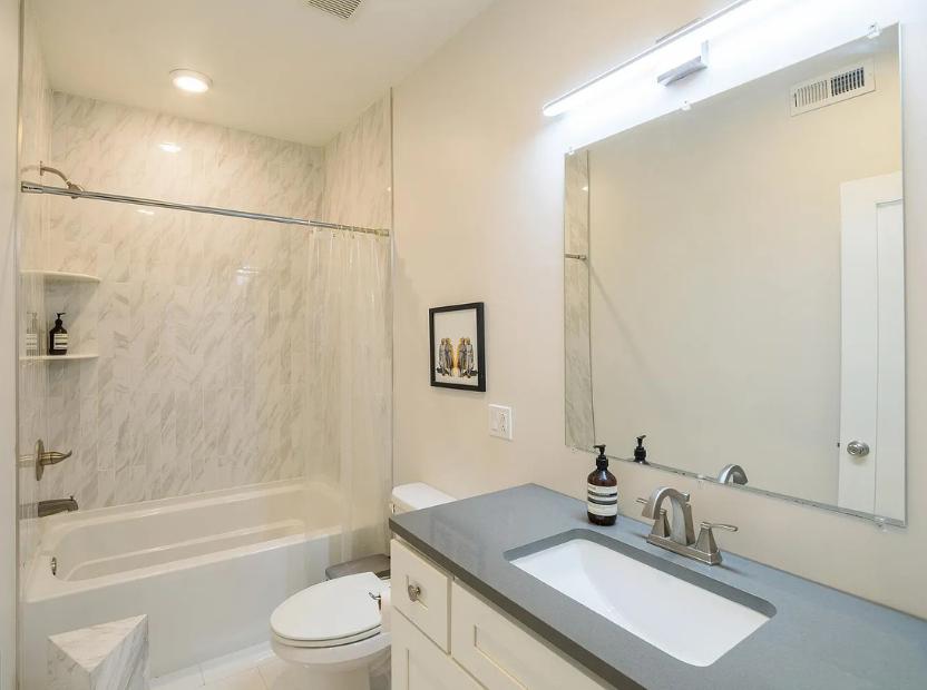 a renovated bathroom with gray countertops after a 203k loan consultation with atlas consultation in philadelphia pa